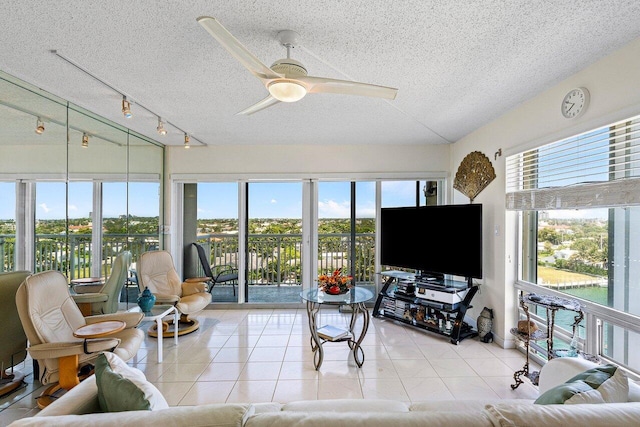 2611 N Riverside Dr Unit 908, Pompano Beach, FL 33062 - living room featuring a textured ceiling, ceiling fan, light tile patterned floors, and rail lighting