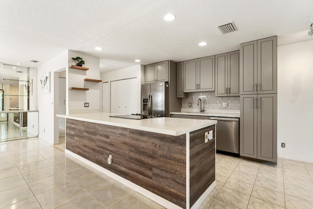 2561 Carambola Cir N Unit 1848Bldg 8, Coconut Creek, FL 33066 - kitchen with stainless steel appliances, light countertops, gray cabinetry, baseboards, and a textured ceiling