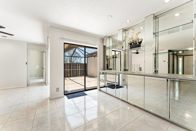 2561 Carambola Cir N Unit 1848Bldg 8, Coconut Creek, FL 33066 - tiled spare room with a ceiling fan, baseboards, recessed lighting, and a textured ceiling