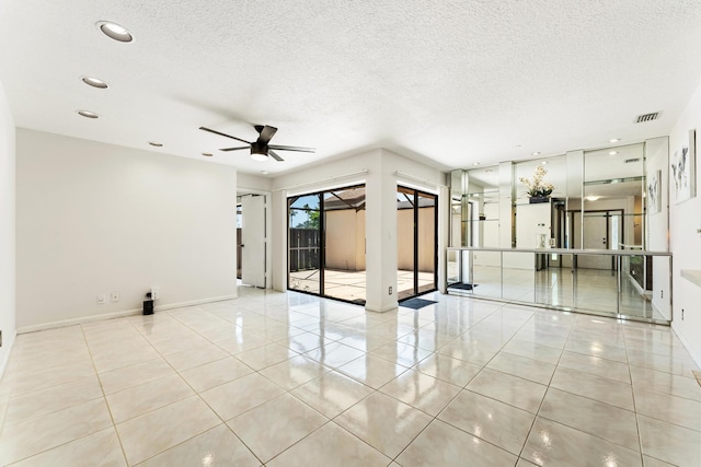 2561 Carambola Cir N Unit 1848Bldg 8, Coconut Creek, FL 33066 - spare room featuring tile patterned flooring, ceiling fan, a textured ceiling, baseboards, and recessed lighting