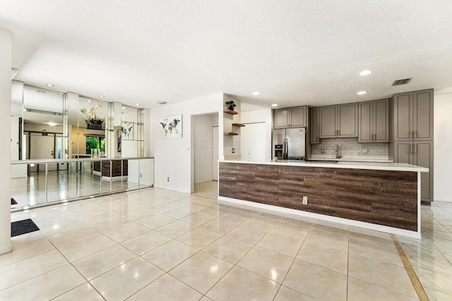 2561 Carambola Cir N Unit 1848Bldg 8, Coconut Creek, FL 33066 - kitchen featuring stainless steel fridge, light countertops, gray cabinets, backsplash, and light tile patterned floors
