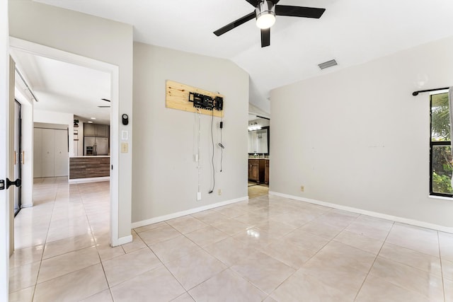 2561 Carambola Cir N Unit 1848Bldg 8, Coconut Creek, FL 33066 - unfurnished bedroom with light tile patterned floors, vaulted ceiling, baseboards, and a ceiling fan