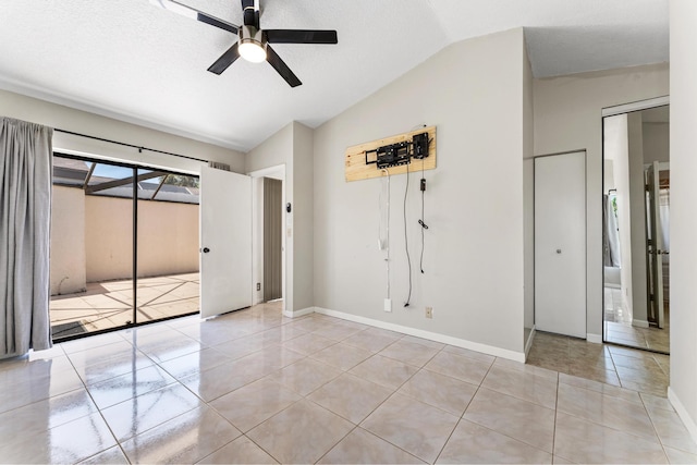 2561 Carambola Cir N Unit 1848Bldg 8, Coconut Creek, FL 33066 - unfurnished bedroom with lofted ceiling, tile patterned flooring, baseboards, and ceiling fan