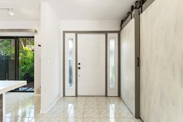 2561 Carambola Cir N Unit 1848Bldg 8, Coconut Creek, FL 33066 - foyer entrance featuring light marble finish floors, a barn door, and baseboards