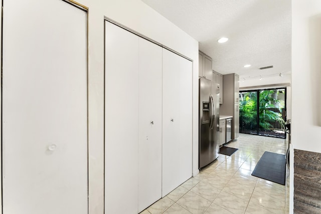 2561 Carambola Cir N Unit 1848Bldg 8, Coconut Creek, FL 33066 - kitchen with stainless steel refrigerator with ice dispenser, a textured ceiling, light tile patterned floors, and recessed lighting