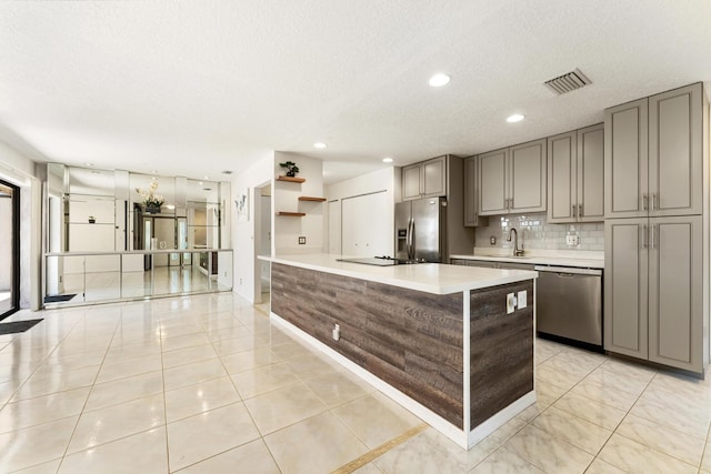 2561 Carambola Cir N Unit 1848Bldg 8, Coconut Creek, FL 33066 - kitchen featuring appliances with stainless steel finishes, a sink, light countertops, gray cabinets, and a textured ceiling