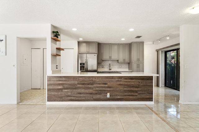 2561 Carambola Cir N Unit 1848Bldg 8, Coconut Creek, FL 33066 - kitchen with stainless steel refrigerator with ice dispenser, light countertops, backsplash, baseboards, and recessed lighting