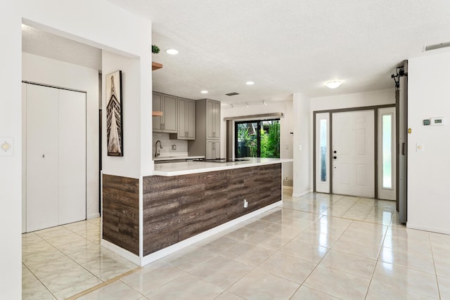 2561 Carambola Cir N Unit 1848Bldg 8, Coconut Creek, FL 33066 - kitchen with gray cabinetry, a textured ceiling, light countertops, a sink, and recessed lighting
