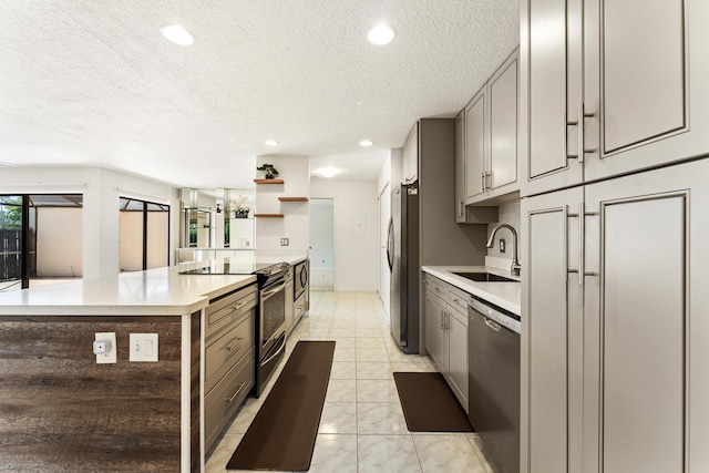 2561 Carambola Cir N Unit 1848Bldg 8, Coconut Creek, FL 33066 - kitchen featuring appliances with stainless steel finishes, gray cabinets, a sink, a textured ceiling, and light countertops