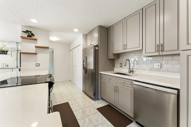 2561 Carambola Cir N Unit 1848Bldg 8, Coconut Creek, FL 33066 - kitchen with stainless steel appliances, a sink, gray cabinetry, light countertops, and a textured ceiling