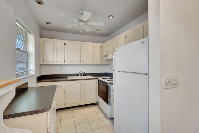 332 Sheffield N, West Palm Beach, FL 33417 - kitchen featuring white appliances, a sink, dark countertops, light tile patterned floors, and under cabinet range hood