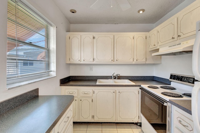 332 Sheffield N, West Palm Beach, FL 33417 - kitchen with white range with electric stovetop, under cabinet range hood, a sink, dark countertops, and ceiling fan