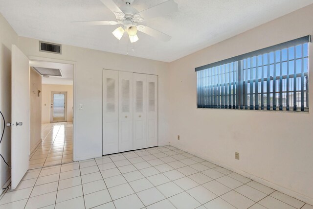 332 Sheffield N, West Palm Beach, FL 33417 - unfurnished bedroom featuring a closet, ceiling fan, baseboards, and light tile patterned floors