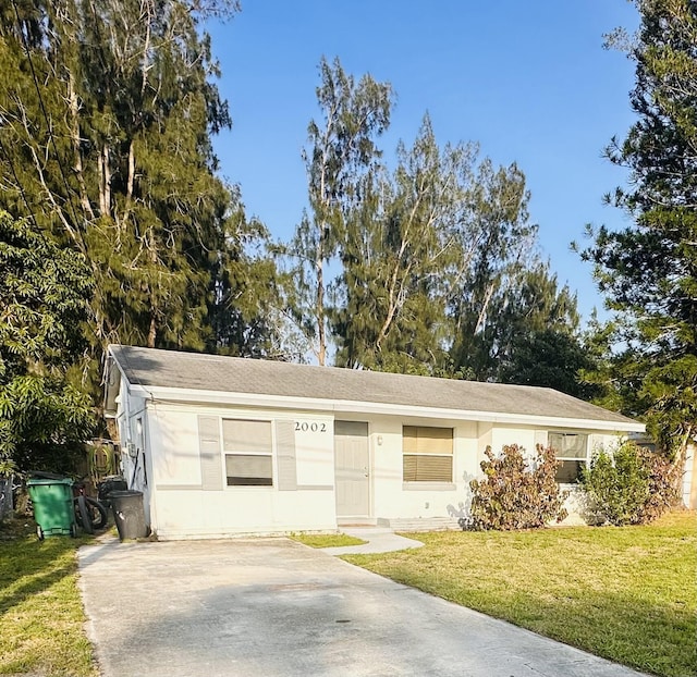 2002 N 50th St, Fort Pierce, FL 34947 - single story home featuring a front lawn and concrete driveway
