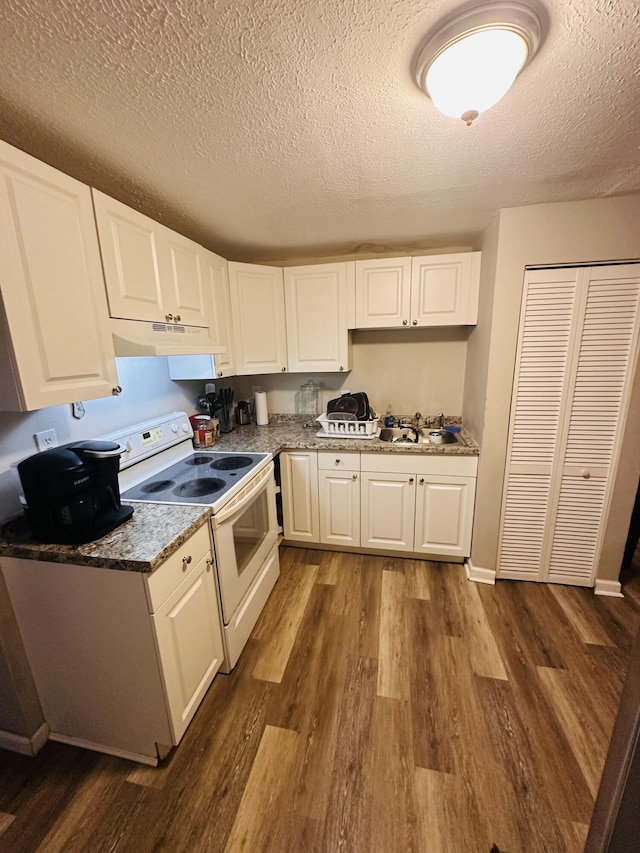 2002 N 50th St, Fort Pierce, FL 34947 - kitchen featuring white range with electric stovetop, dark wood-type flooring, a textured ceiling, white cabinets, and under cabinet range hood