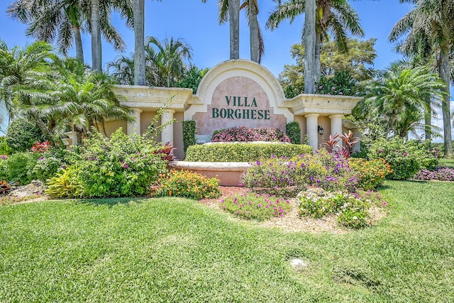 community / neighborhood sign with a lawn