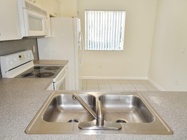 5927 Riverside Ave, Tamarac, FL 33321 - kitchen with white appliances, a sink, tile patterned floors, and light countertops