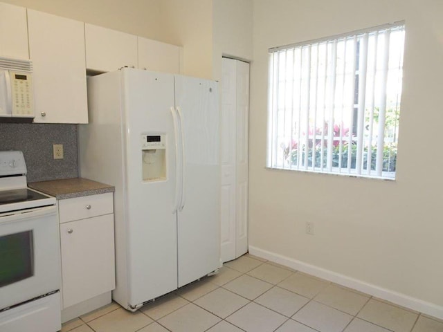 5927 Riverside Ave, Tamarac, FL 33321 - kitchen featuring white appliances, decorative backsplash, light tile patterned floors, and white cabinets