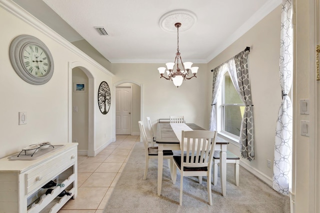 401 SE Ron Rico Ter, Port Saint Lucie, FL 34983 - dining area featuring arched walkways, a chandelier, ornamental molding, baseboards, and light tile patterned floors
