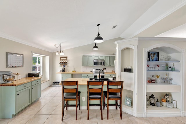 401 SE Ron Rico Ter, Port Saint Lucie, FL 34983 - kitchen with green cabinets, appliances with stainless steel finishes, butcher block countertops, crown molding, and vaulted ceiling