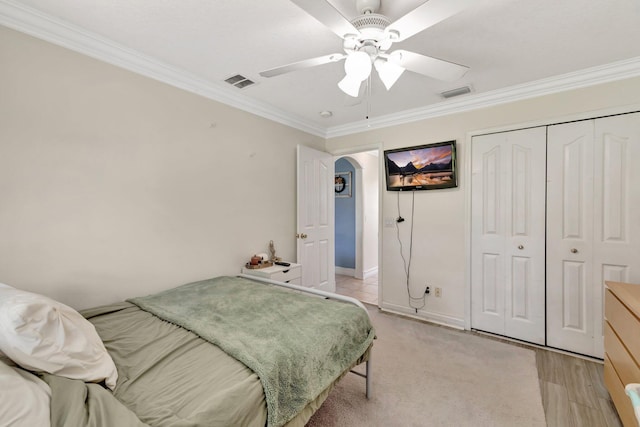 401 SE Ron Rico Ter, Port Saint Lucie, FL 34983 - bedroom with crown molding, arched walkways, a closet, a ceiling fan, and baseboards