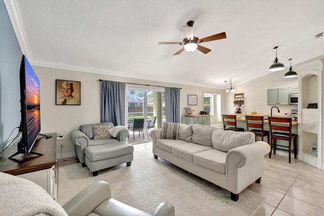 401 SE Ron Rico Ter, Port Saint Lucie, FL 34983 - living area with vaulted ceiling, ornamental molding, ceiling fan, baseboards, and light tile patterned flooring