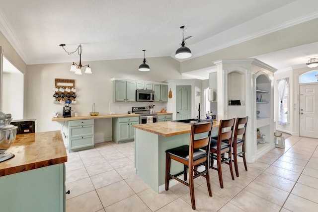 401 SE Ron Rico Ter, Port Saint Lucie, FL 34983 - kitchen with butcher block countertops, stainless steel appliances, green cabinets, light tile patterned floors, and ornamental molding