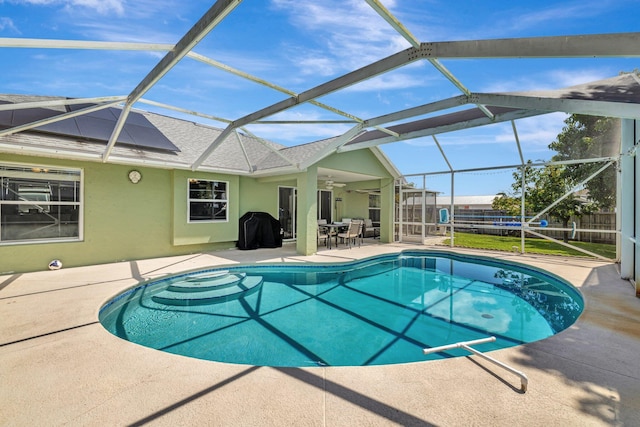 401 SE Ron Rico Ter, Port Saint Lucie, FL 34983 - view of pool with a patio, a fenced backyard, a ceiling fan, and glass enclosure