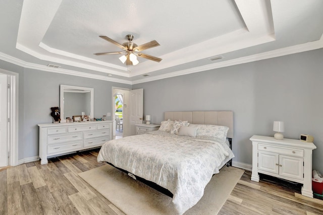 401 SE Ron Rico Ter, Port Saint Lucie, FL 34983 - bedroom with a raised ceiling, light wood-type flooring, ceiling fan, ornamental molding, and baseboards