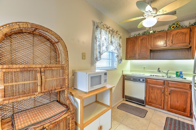 25 Lake Vista Trl Unit 203, Port Saint Lucie, FL 34952 - kitchen with white appliances, a sink, light countertops, light tile patterned floors, and ceiling fan