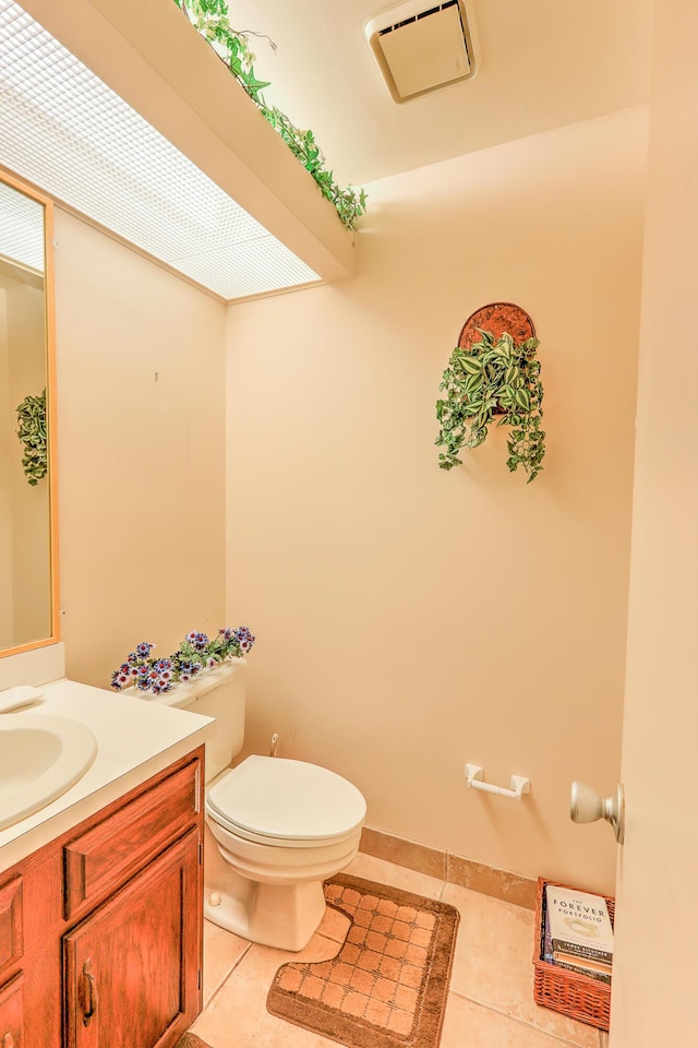 25 Lake Vista Trl Unit 203, Port Saint Lucie, FL 34952 - half bath with tile patterned flooring, toilet, and vanity