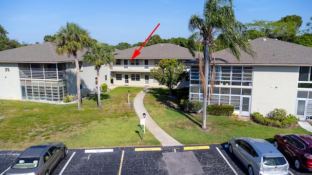 25 Lake Vista Trl Unit 203, Port Saint Lucie, FL 34952 - view of building exterior featuring uncovered parking