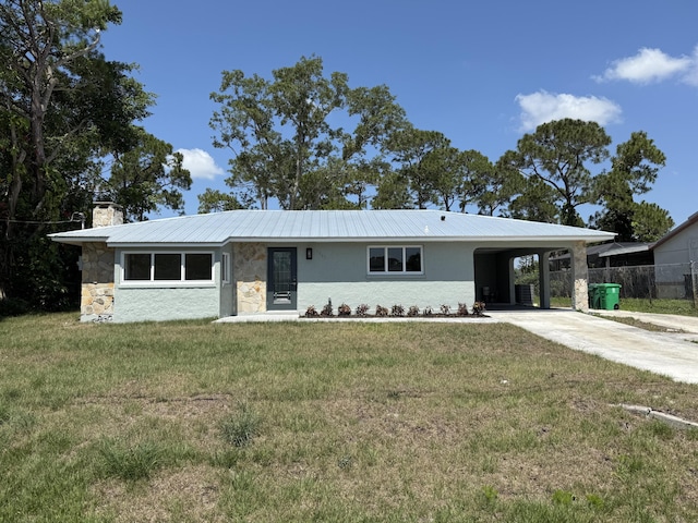 1962 SE Manth Ln, Port Saint Lucie, FL 34983 - ranch-style house with concrete driveway, a chimney, stone siding, a carport, and stucco siding