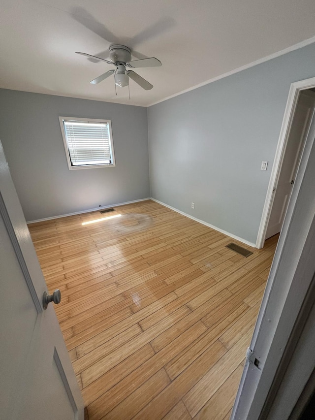 702 48th St, West Palm Beach, FL 33407 - unfurnished room featuring ceiling fan, baseboards, light wood-style flooring, and crown molding