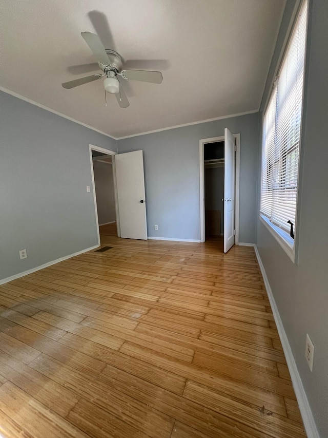 702 48th St, West Palm Beach, FL 33407 - unfurnished bedroom featuring light wood-style floors, ornamental molding, ceiling fan, baseboards, and a closet