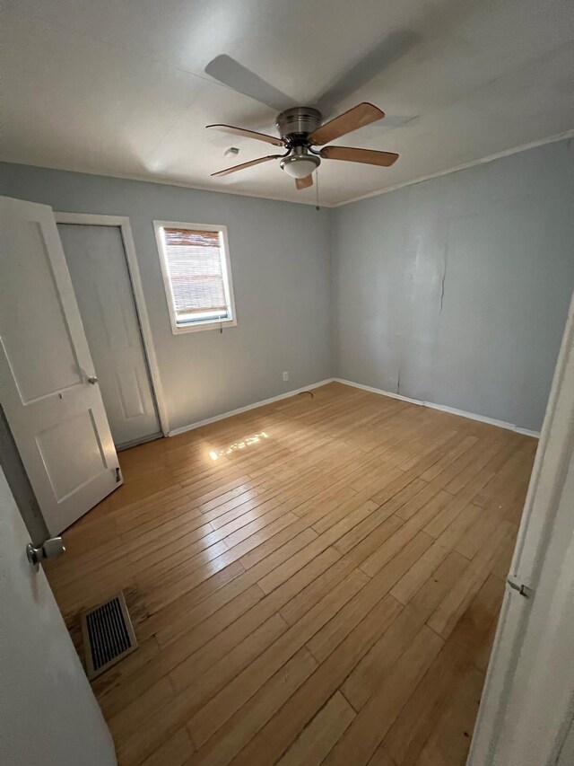 702 48th St, West Palm Beach, FL 33407 - unfurnished bedroom featuring light wood-style floors, baseboards, and ceiling fan