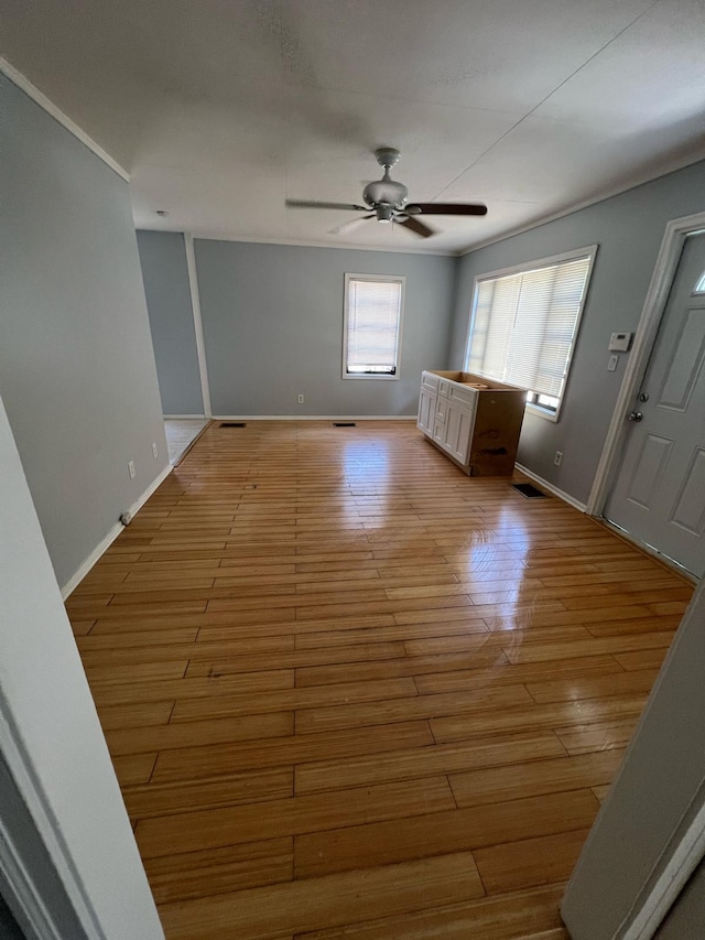 702 48th St, West Palm Beach, FL 33407 - unfurnished living room featuring ceiling fan, baseboards, and light wood-type flooring