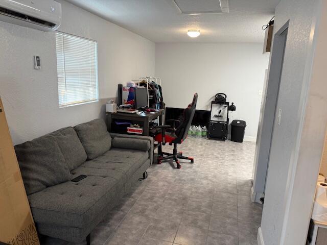 office area featuring an AC wall unit and attic access