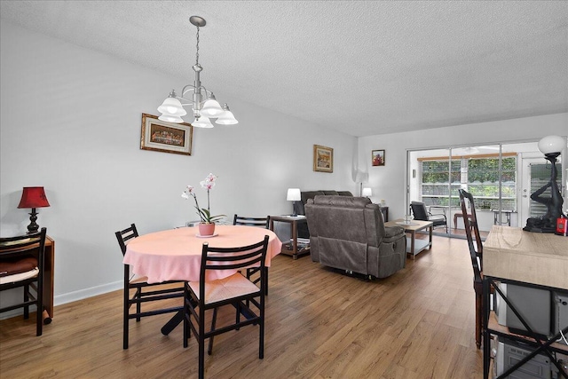 884 Worcester Ln, Lake Worth, FL 33467 - dining space with a textured ceiling, a chandelier, and wood finished floors