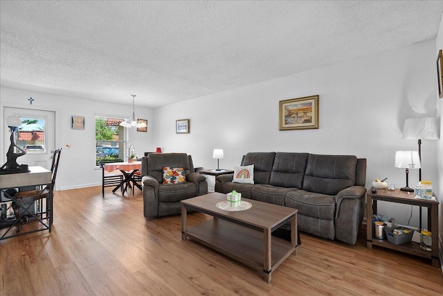 884 Worcester Ln, Lake Worth, FL 33467 - living area with wood finished floors, a textured ceiling, a chandelier, and baseboards