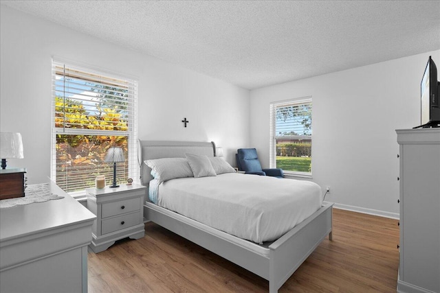 884 Worcester Ln, Lake Worth, FL 33467 - bedroom featuring a textured ceiling and light wood-style floors