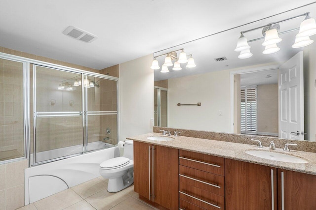 610 Clematis St Unit 236, West Palm Beach, FL 33401 - bathroom featuring enclosed tub / shower combo, toilet, tile patterned flooring, and double vanity