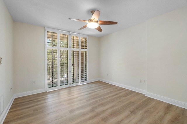 610 Clematis St Unit 236, West Palm Beach, FL 33401 - empty room featuring light wood-style floors, ceiling fan, baseboards, and floor to ceiling windows