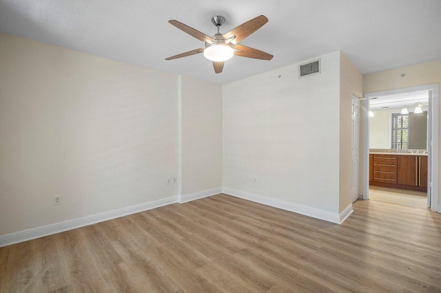 610 Clematis St Unit 236, West Palm Beach, FL 33401 - unfurnished room featuring light wood finished floors, ceiling fan, and baseboards
