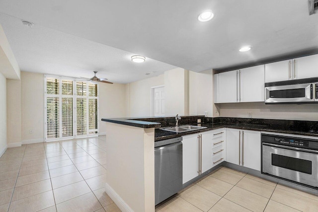 610 Clematis St Unit 236, West Palm Beach, FL 33401 - kitchen with appliances with stainless steel finishes, a peninsula, light tile patterned floors, a ceiling fan, and a sink