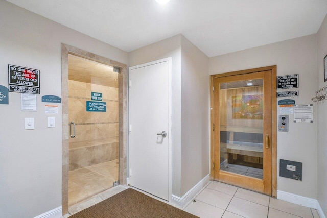610 Clematis St Unit 236, West Palm Beach, FL 33401 - bathroom featuring baseboards, tile patterned flooring, a stall shower, and a relaxing sauna