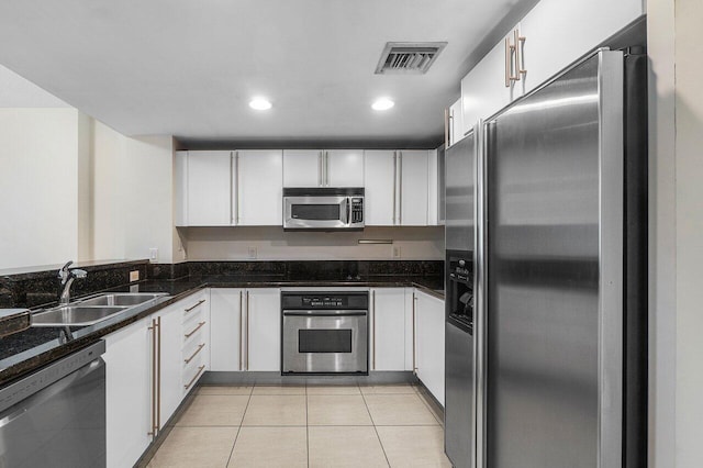 610 Clematis St Unit 236, West Palm Beach, FL 33401 - kitchen with appliances with stainless steel finishes, a sink, white cabinetry, light tile patterned floors, and recessed lighting