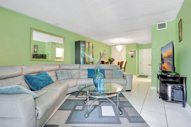 2029 NW 46th Ave Unit E204, Lauderhill, FL 33313 - living area with light tile patterned floors, a textured ceiling, and baseboards
