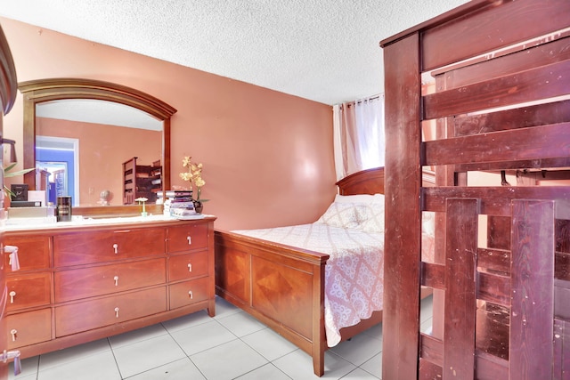 2029 NW 46th Ave Unit E204, Lauderhill, FL 33313 - bedroom with a textured ceiling and light tile patterned flooring