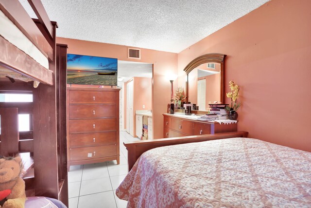 2029 NW 46th Ave Unit E204, Lauderhill, FL 33313 - bedroom with light tile patterned flooring and a textured ceiling
